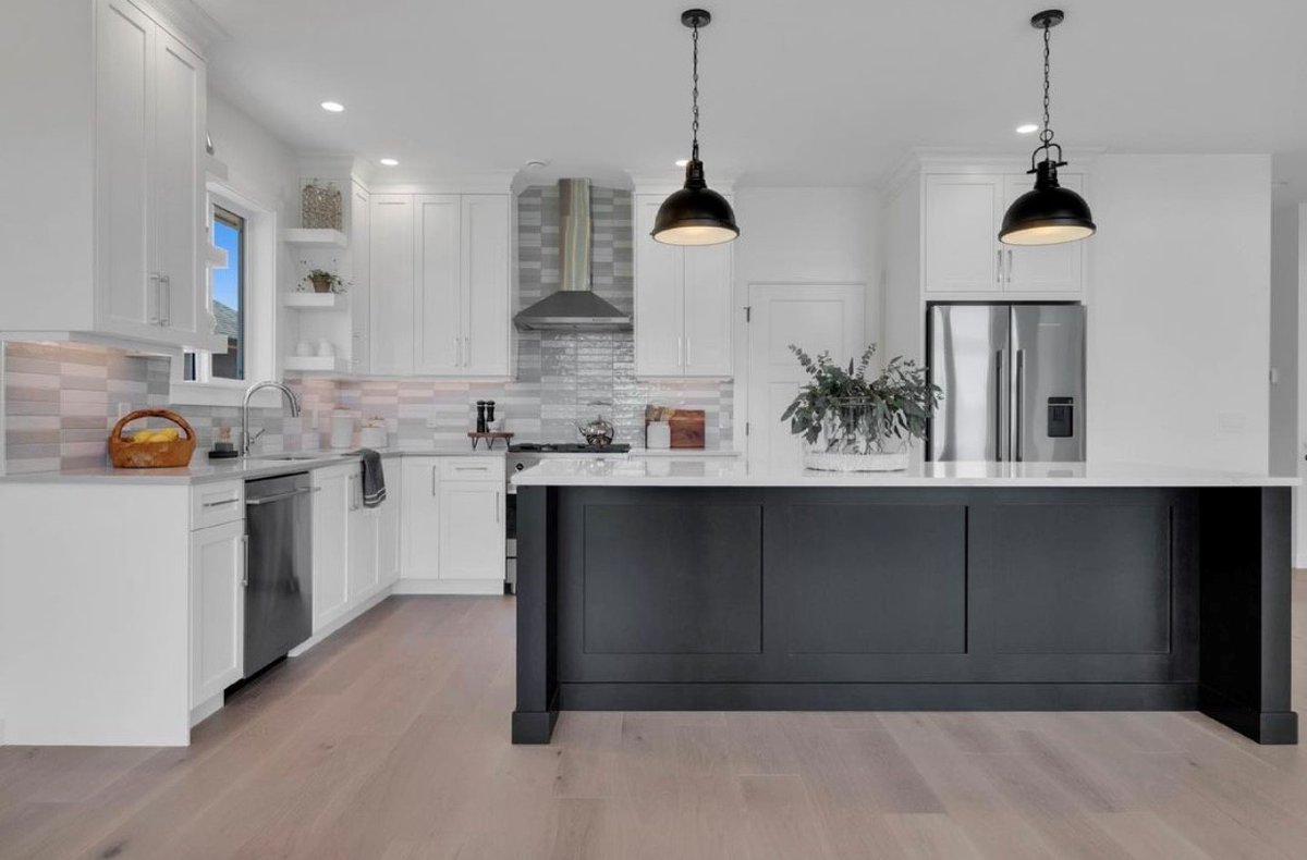Our Classica Plus hood adds premium features like LED lamps, electronic controls and seamless edges to this asymmetrical kitchen designed by Tiffany Verschuur &amp; Coastal Custom Homes