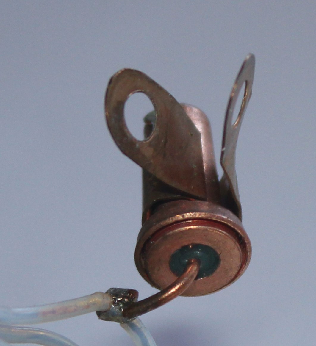 kenshirriff's tweet photo. Can anyone identify this 1960s mystery component for me? It's copper, 15mm long, bolted to ground. I'd think "diode" but it measures 10Ω either direction. It's in a low-current battery device that is powered through this. It's much chonkier than seems reasonable. Any ideas? https://t.co/Ygy5eMSSVT