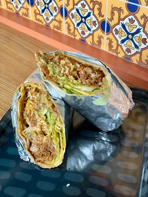 Check out that cross-section! Packed full of our house-smoked pork, handmade salsas and hot sauces and all the extras you can handle!