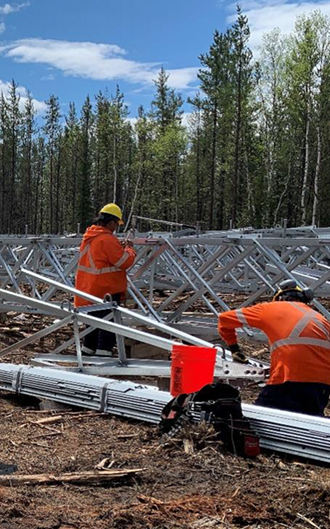 wataynikaneyap's tweet photo. An assembly crew builds structures at a fly-yard near #NorthCaribouLake First Nation. When this picture was taken in early June, the crew had built 26 structures with over 100 more structures to go for this #WatayPower transmission line segment. #IndigenousOwnership https://t.co/DMZjhYjmLD