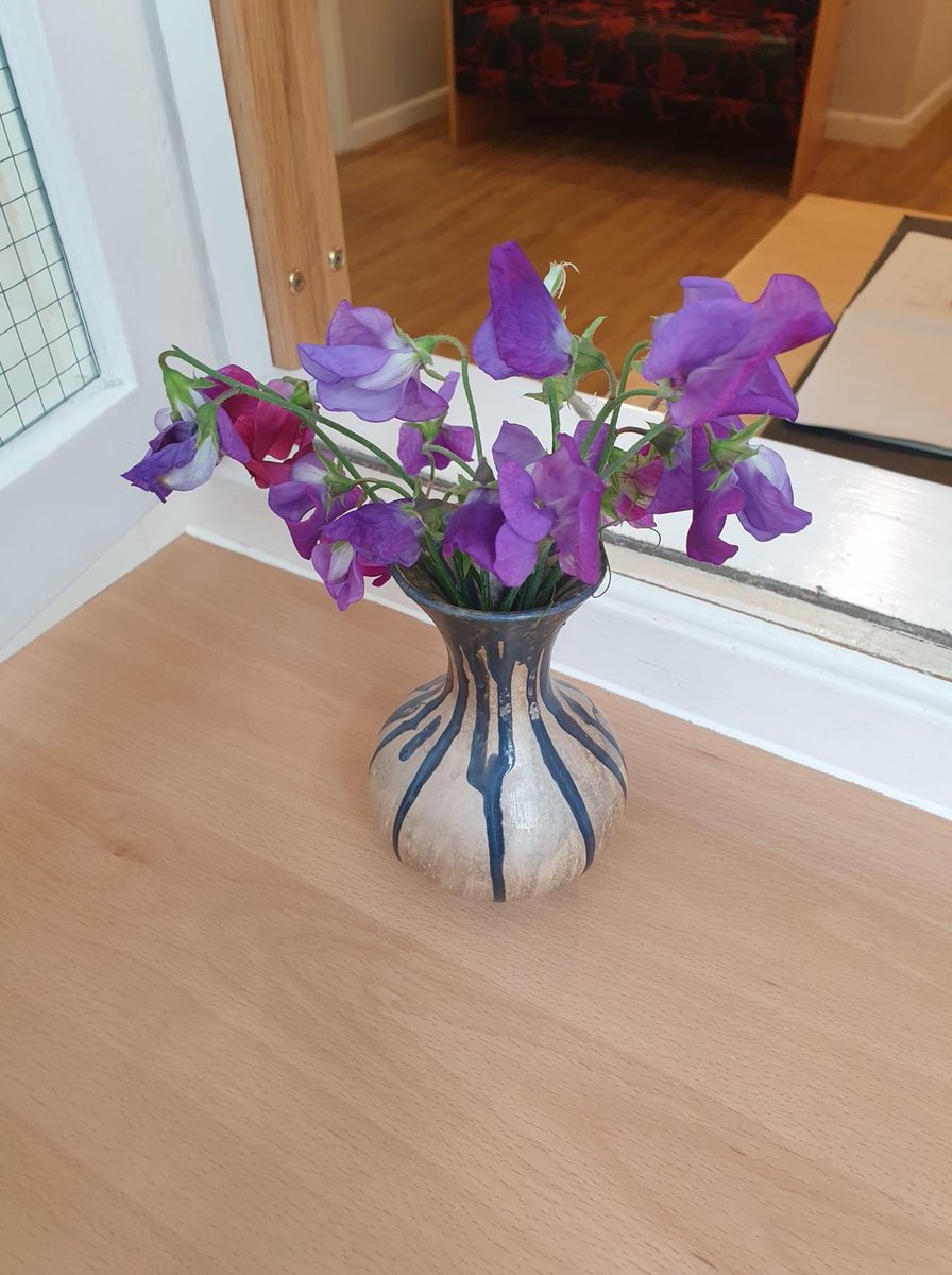 DHCRehab's tweet photo. Lovely sweet peas picked from our sensory garden at Nightingale House and put in a vase made with the patients in our pottery group. Their fragrance is filling our Reception Area. https://t.co/JddwrVYzVH