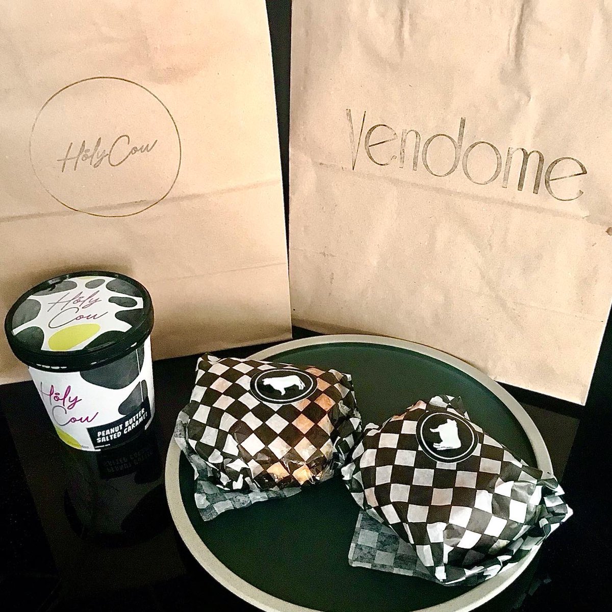 CulinaireMag's tweet photo. Thx so much to @VendomeYYC #holycow for coming to the rescue on this meltingly hot day! Two burgers on your👌onion burger buns all washed down with @MonteCreekRanch #cabmerlot and a pint of #peanutbutter & #saltedcaramel #gelato. All on our new #spiritware plates! Made our day! https://t.co/z6XIcSLn0x