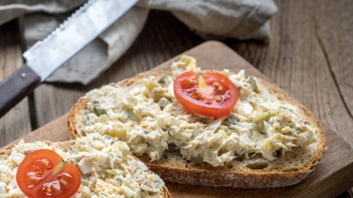 Toast with fish on top and tomato slices