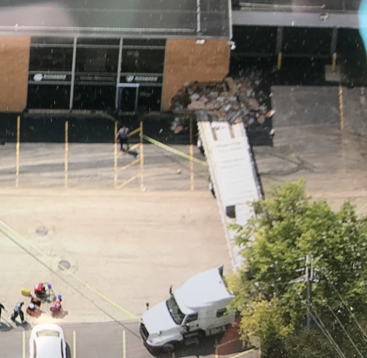 NBCSky5's tweet photo. A semi crashed into Richards Commercial Printing Building in an industrial area.  No injuries reported yet, but this is still a technical rescue and search. https://t.co/p8hBJJ7fy5