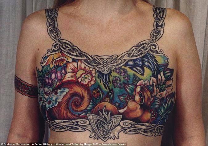 This is the photo that Facebook keep taking down and keeps disappearing from all pages including comments. See if we can keep it going. This woman had this tattoo to cover her mastectomy scars. I think it is beautiful and brave. What is so offensive Facebook?