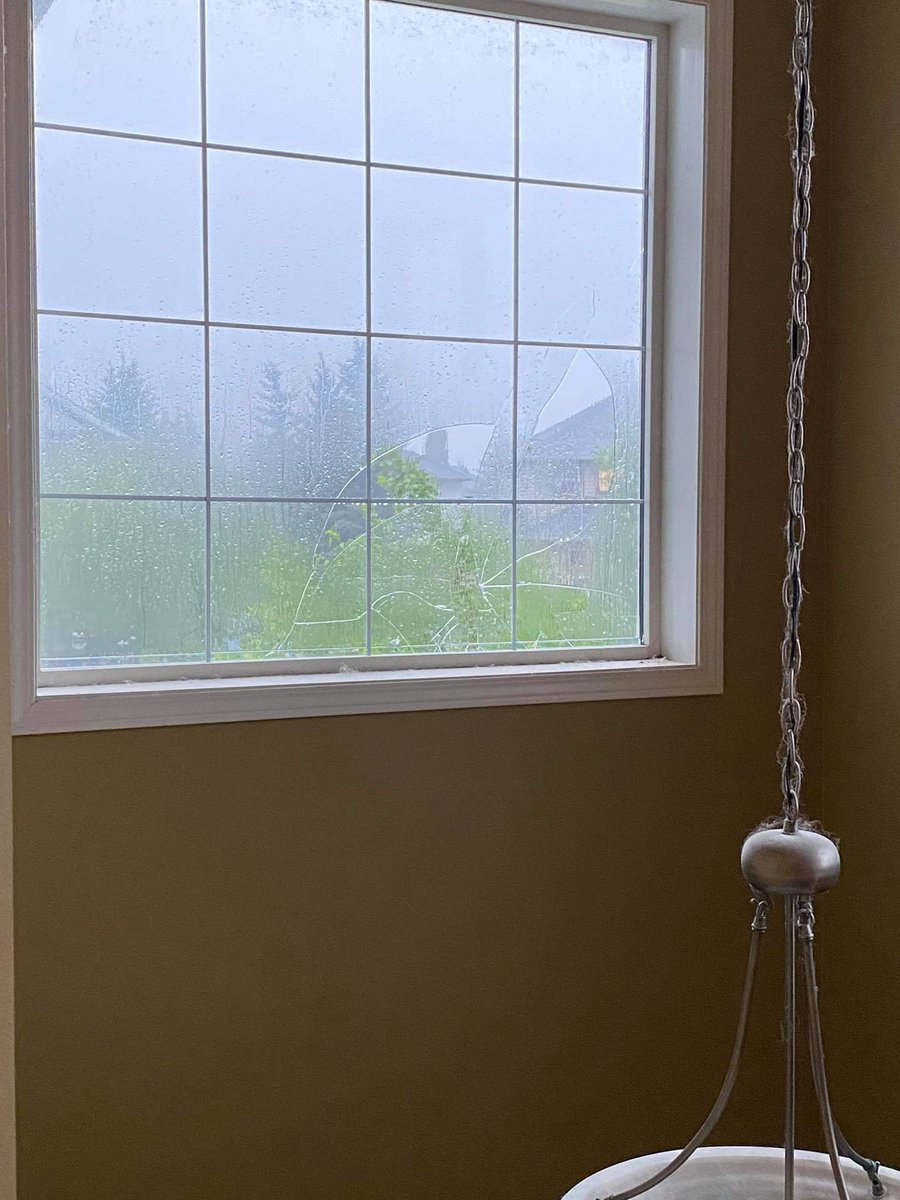 btk_weather's tweet photo. Broken windows at home in Somerset in SW Calgary. Picture from the fiance. Golf balls and bigger came down.  Chase is over time to head home and assess the damage ug #abstorm https://t.co/2ouaUajH9S