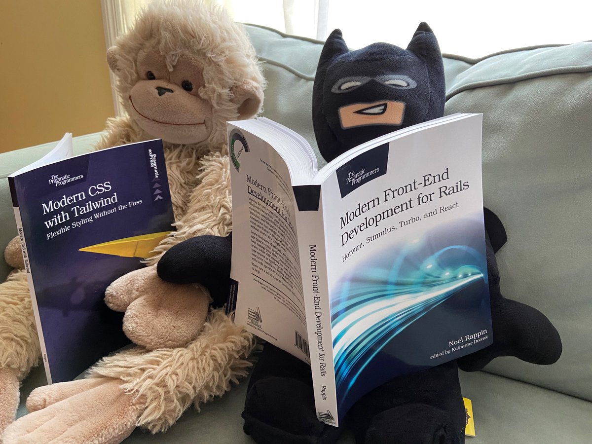 A plush Lego Batman appears to read Modern Front-End Development for Rails accompanied by a plush monkey reading Modern CSS with Tailwind
