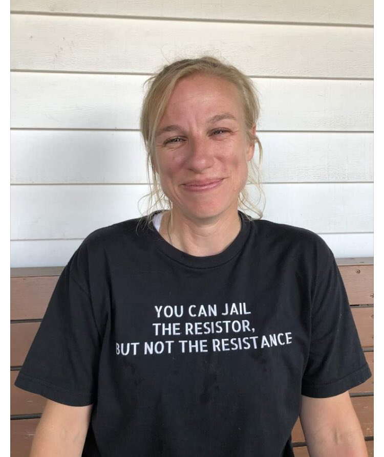 A photo of Jessica smiling. Her shirt reads “You can jail the resistor, but not the resistance”.