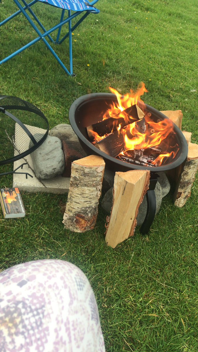 Propping up our fire with rocks because this pit came without four of its screws. Disappointed with <a href="/gooutdoors/">GO Outdoors</a> for this :/