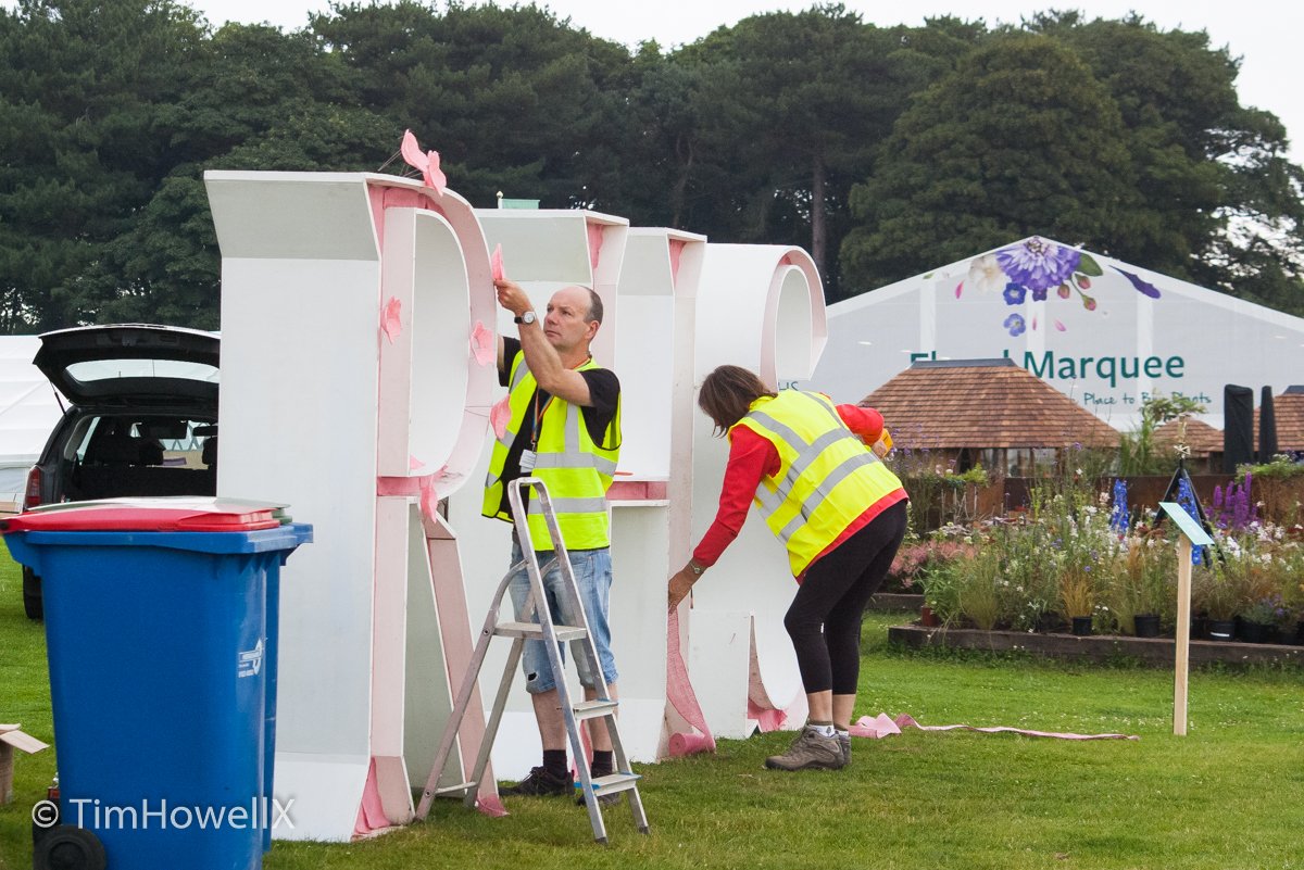 TimHowellX's tweet photo. #CountdownToTatton #RHSTatton 10 days to go. Florist @jpmoseley produces the most spectacular displays at @the_rhs shows. Here he is starting work on the “RHS” letters and here's the completed display with the very beautiful @misJORGIEPORTER plus in the last image it's me😀 https://t.co/aDr7t4rt3K