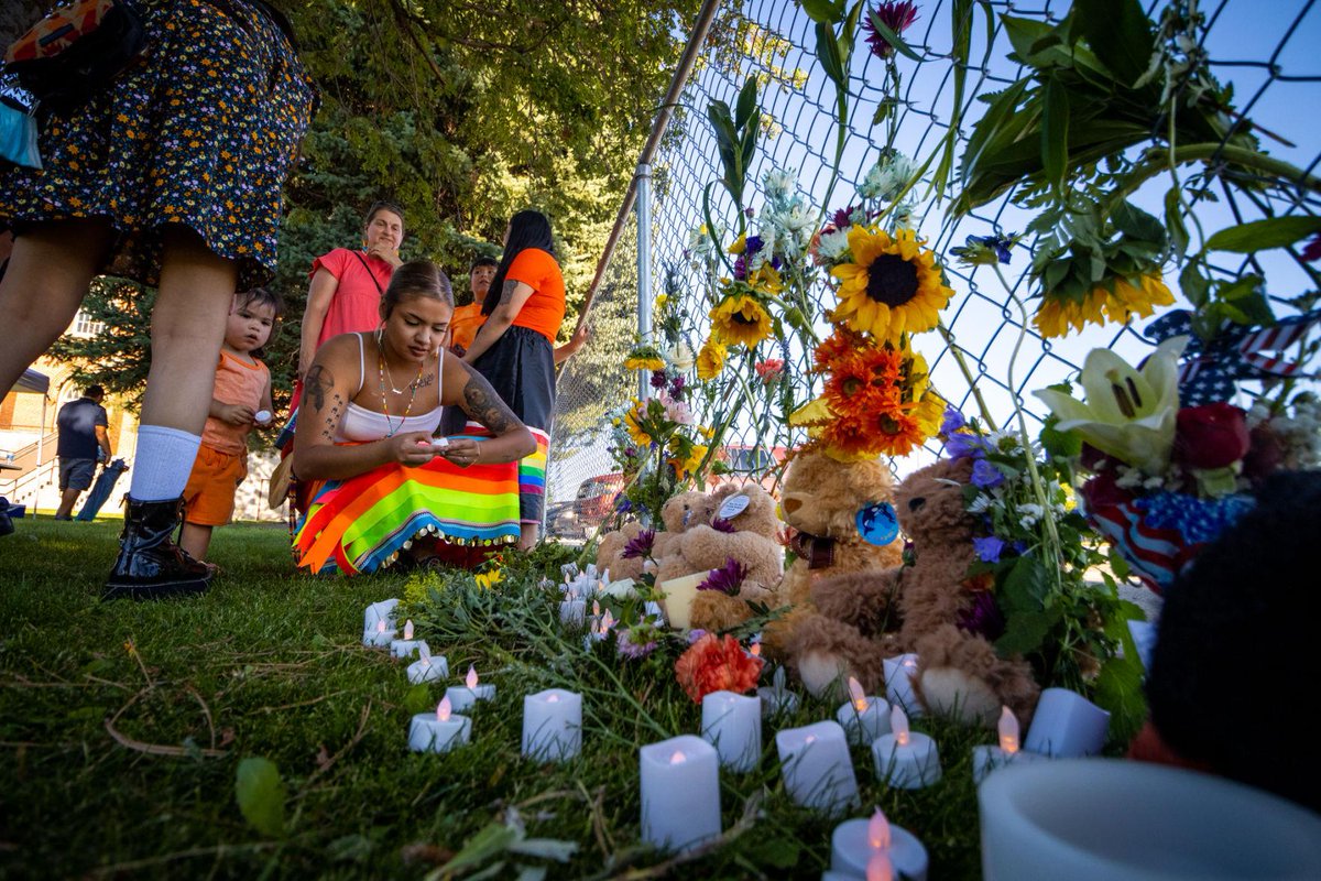 JimVanNostrand's tweet photo. In the courtyard of the St. Ignatius Mission Parish, a group of people braved the heat wave Saturday evening to remember lost children and survivors of Native American boarding schools. #boardingschool https://t.co/H3m5W70GrO https://t.co/5m5y9qfUxa
