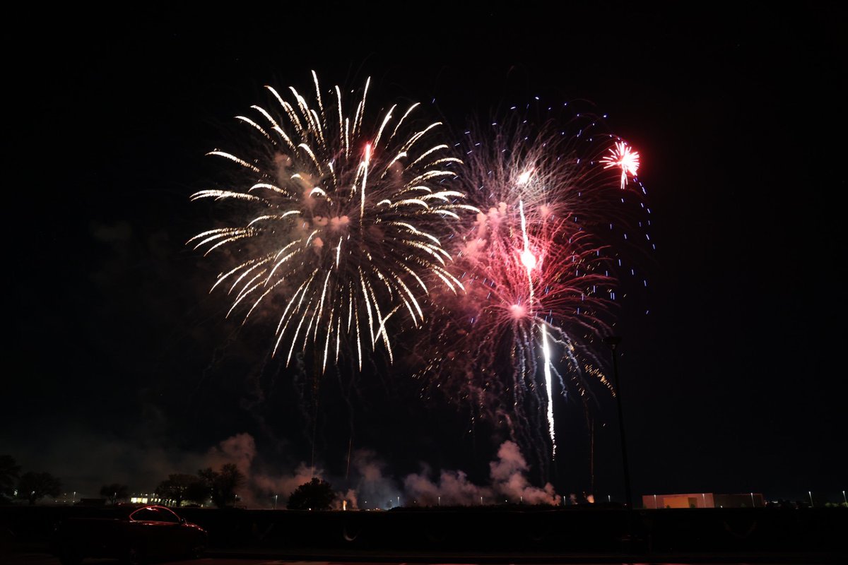 Two firework clusters in the night sky. 