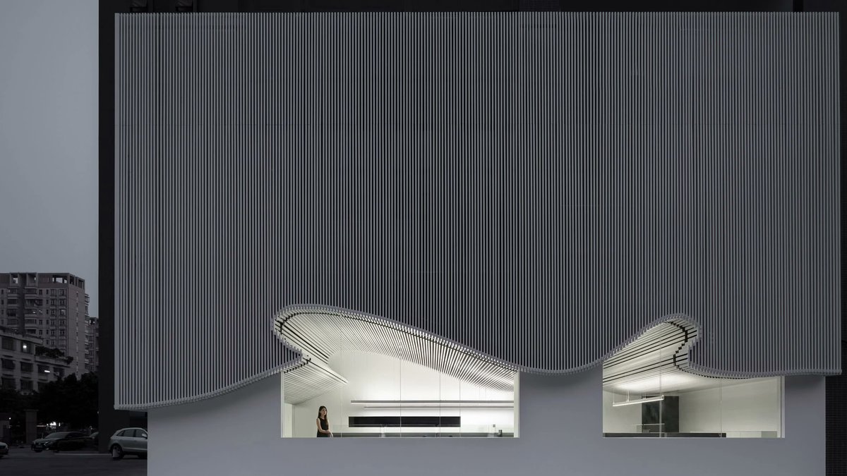 dezeen's tweet photo. A curvilinear facade and undulating ceiling feature in this office in China: https://t.co/rMpyuCwJRT https://t.co/zK0orve8jL