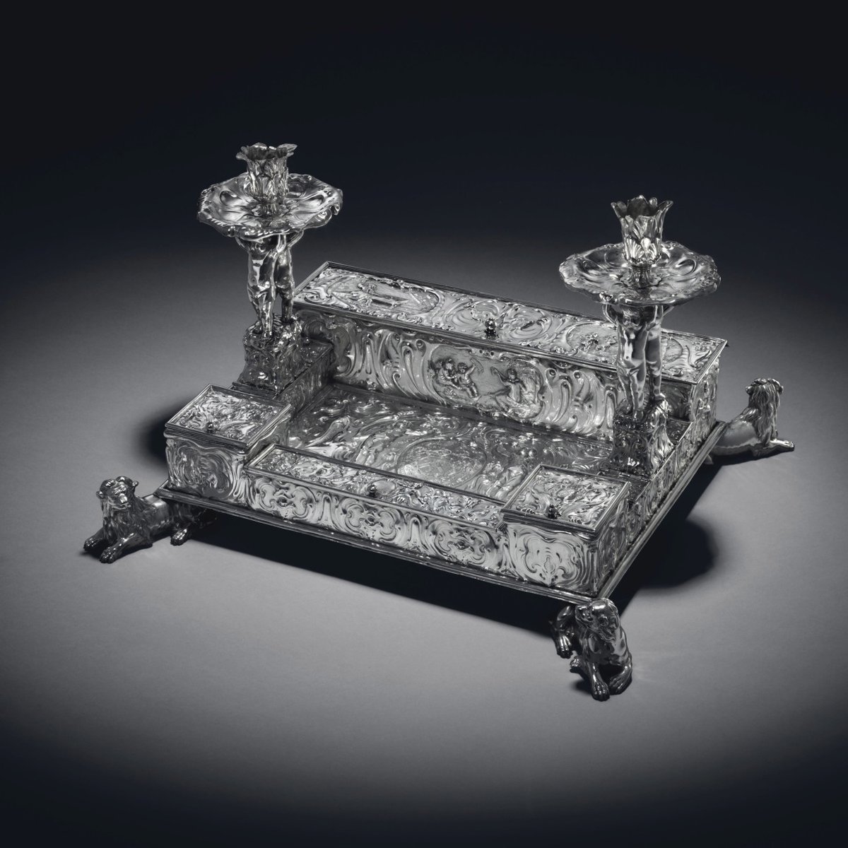 ChristiesInc's tweet photo. #WhatIsAClassic This incredibly rare silver inkstand was designed by King Charles I's silversmith, the Dutch master of the Auricular style, Christian van Vianen. The Auricular style is characterised by the ear-like motifs, fluid masks and grotesque figures. https://t.co/NiWw1yFQs2