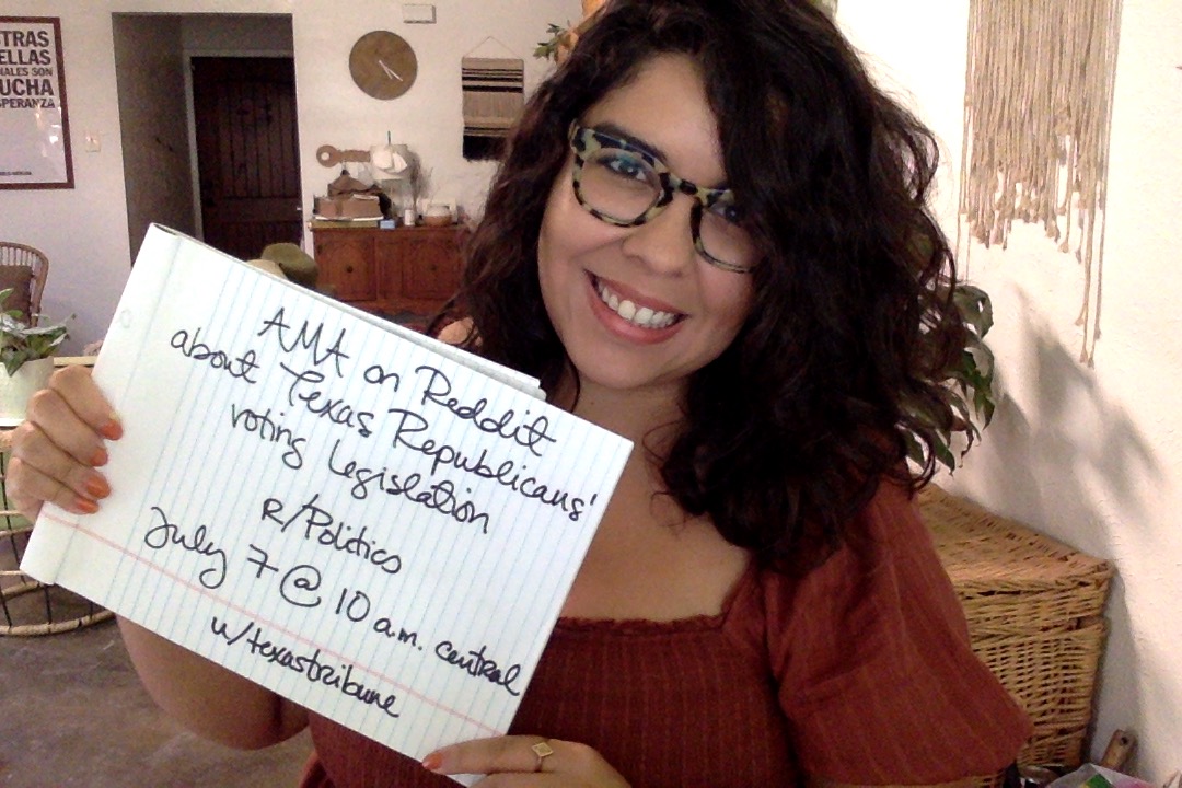 Alexa Ura holds a sign about her upcoming AMA in r/Politics on July 7 at 10 a.m. Central. 