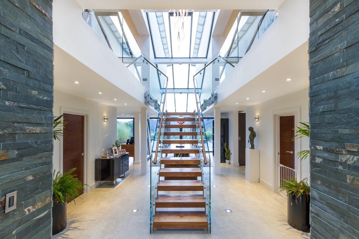 A beautiful walnut and glass staircase designed by <a href="/_BCA_/">BenCunliffeArchitect</a> at our #grasmere project. #LakeDistrict #architecture #contemporarydesign #familyhome