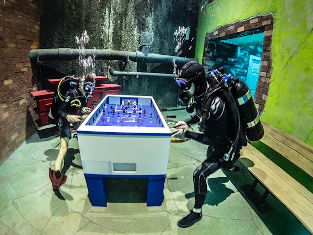 TheNationalNews's tweet photo. Subterranean arcades, lounge rooms, &amp; more. This is the underwater world of #DeepDiveDubai, the world’s deepest freshwater pool. 

Grab your scuba gear, or click here to see more of the experience paying tribute to the UAE’s pearl diving heritage:
https://t.co/OxLEpk8TbS https://t.co/mnf8a0uY8E