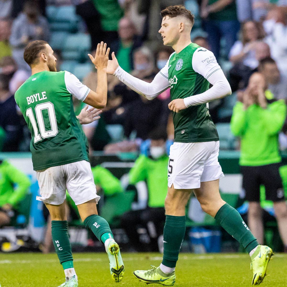Martin Boyle and Kevin Nisbet high-five in celebration.