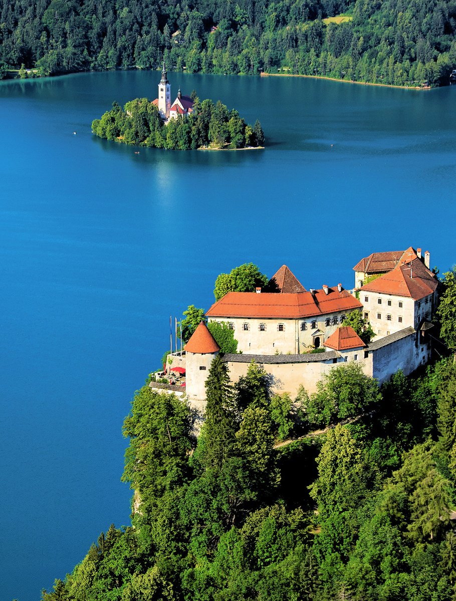 BLED CASTLE - #Slovenia's oldest #castle was built on a precipice above #LakeBled more than a thousand years ago. (photo: Matevz Lenarcic #photography) #ifeelsLOVEnia #travel #aerialphotography All you need to know to visit #Bled Castle: travelslovenia.org/bled-castle/