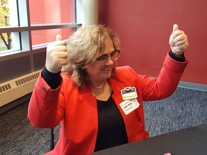 Jule Ann Lieberman smiles and raises both hands with thumbs up