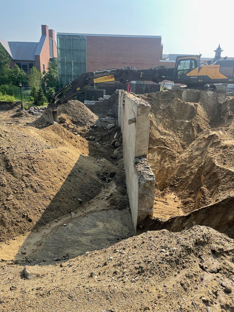 EnviroVantage's tweet photo. Phillips Exeter Academy - new dormitory site work. This foundation wall is 15 inches wide by 15 feet tall and it's being carefully excavated to perform abatement on the asbestos-containing mastic. #demolition #remediation #asbestosabatement #environmental #restoration #recycle https://t.co/lca0zUaG37