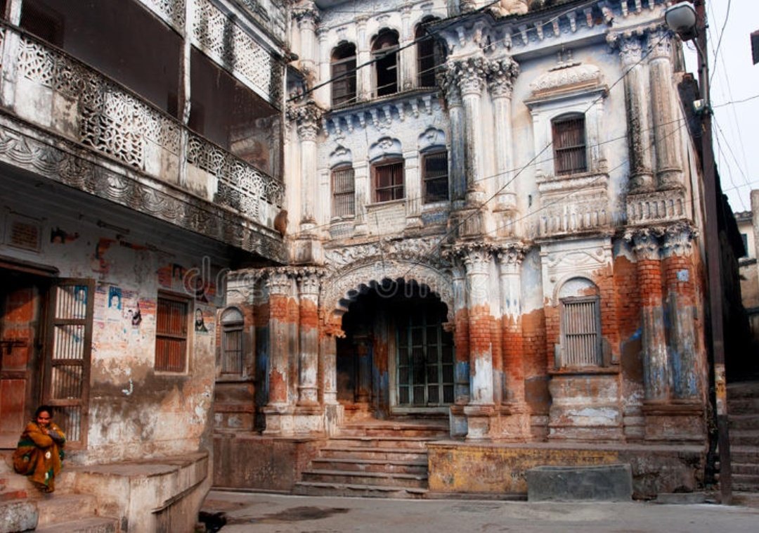 One woman sits on the doorstep in a beautiful crumbling Indian city Ayodhya, #India
