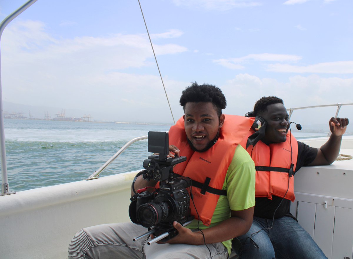 UWICFP's tweet photo. These student filmmakers were smiling and hard at work. In today’s behind the scenes, this team took a ride out on the sea to get footage for their film "Instactivist". Can you guess where we were today?  #UWIcommunityfilmproject #UWICFP #UWI #kheamproject #kingstonharbour #MSS https://t.co/OxGMcFTGYs