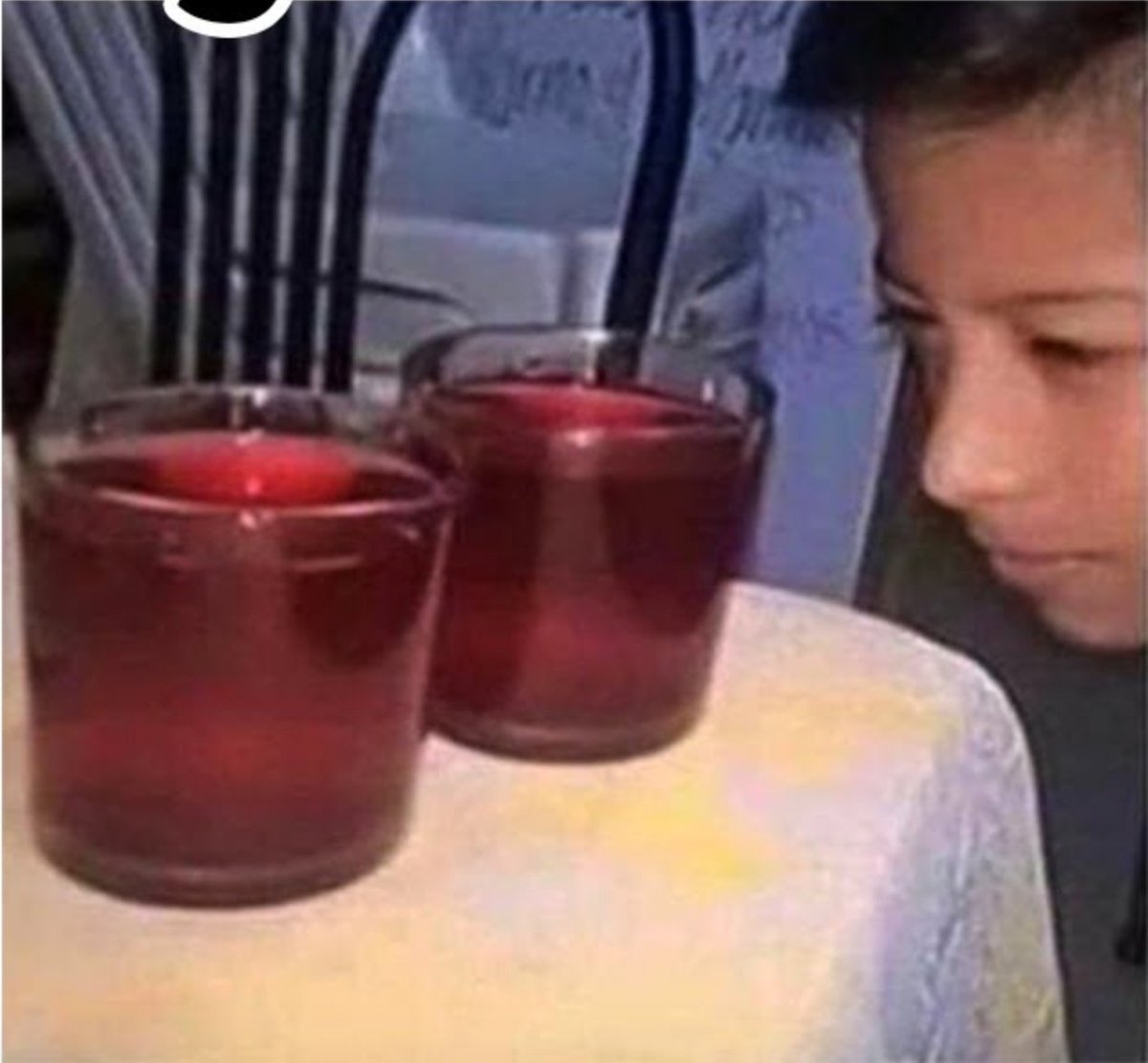 Siblings meme - boy checking two cups of kool-aid to see that they are level