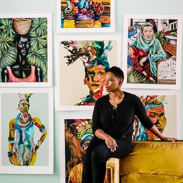 The artist in front of her one-of-a-kind prints - there’s a ton of unique beauty and power in this shot 📸 l8r.it/0hKm #homestyledecor #BlackOwnedSmallBusiness #interiordesigning #anniversarygifts #heirlooms #africaninspired #limitededitionart #portraiture