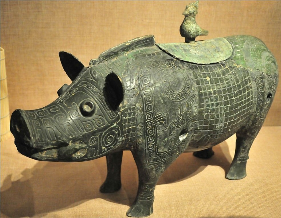 Chinese bronze boar-shaped ritual vessel from the late Shang dynasty (1600–1046 BCE). It was discovered in 1981 in Chuanxingshan, Xiangtan County, Hunan when a villager was levelling the foundations for a new house. Hunan Provincial Museum. Image source: Wikimedia Commons.