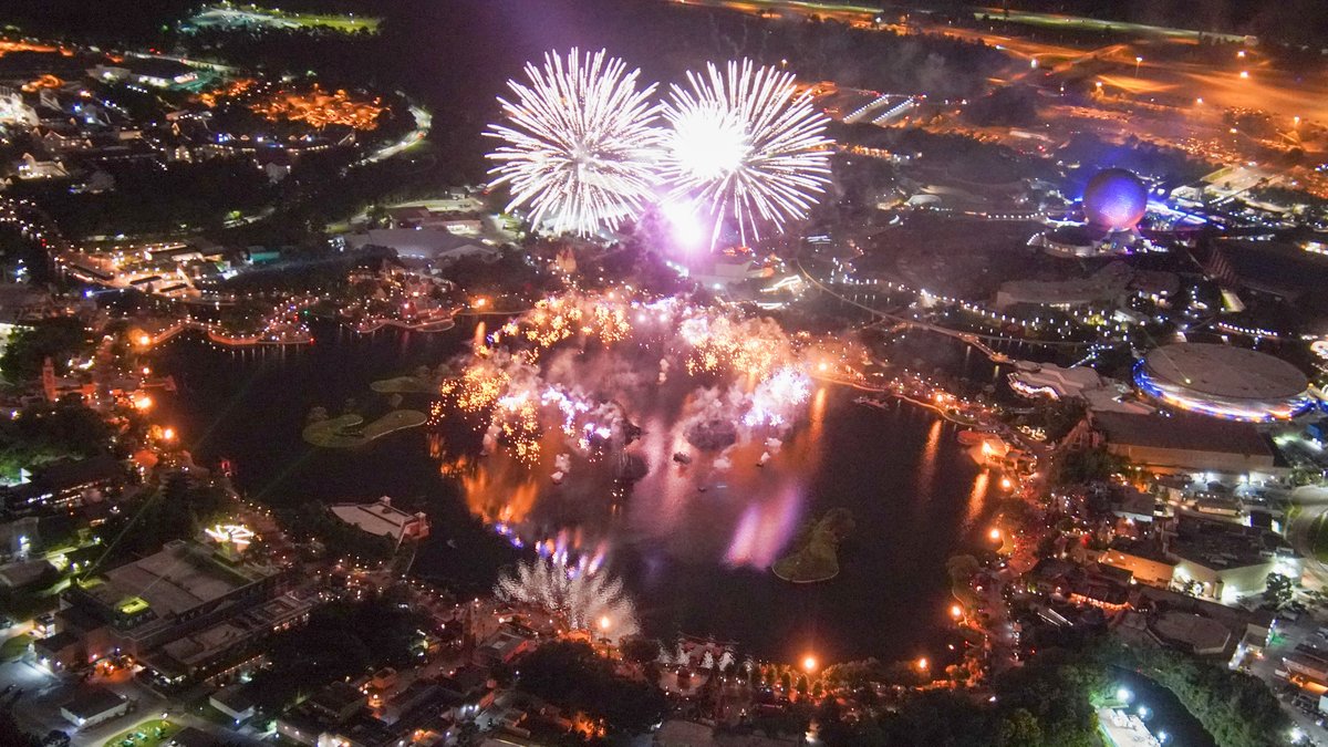 Fireworks are reflecting in World Showcase Lagoon in this aerial photo of EPCOT Forever.