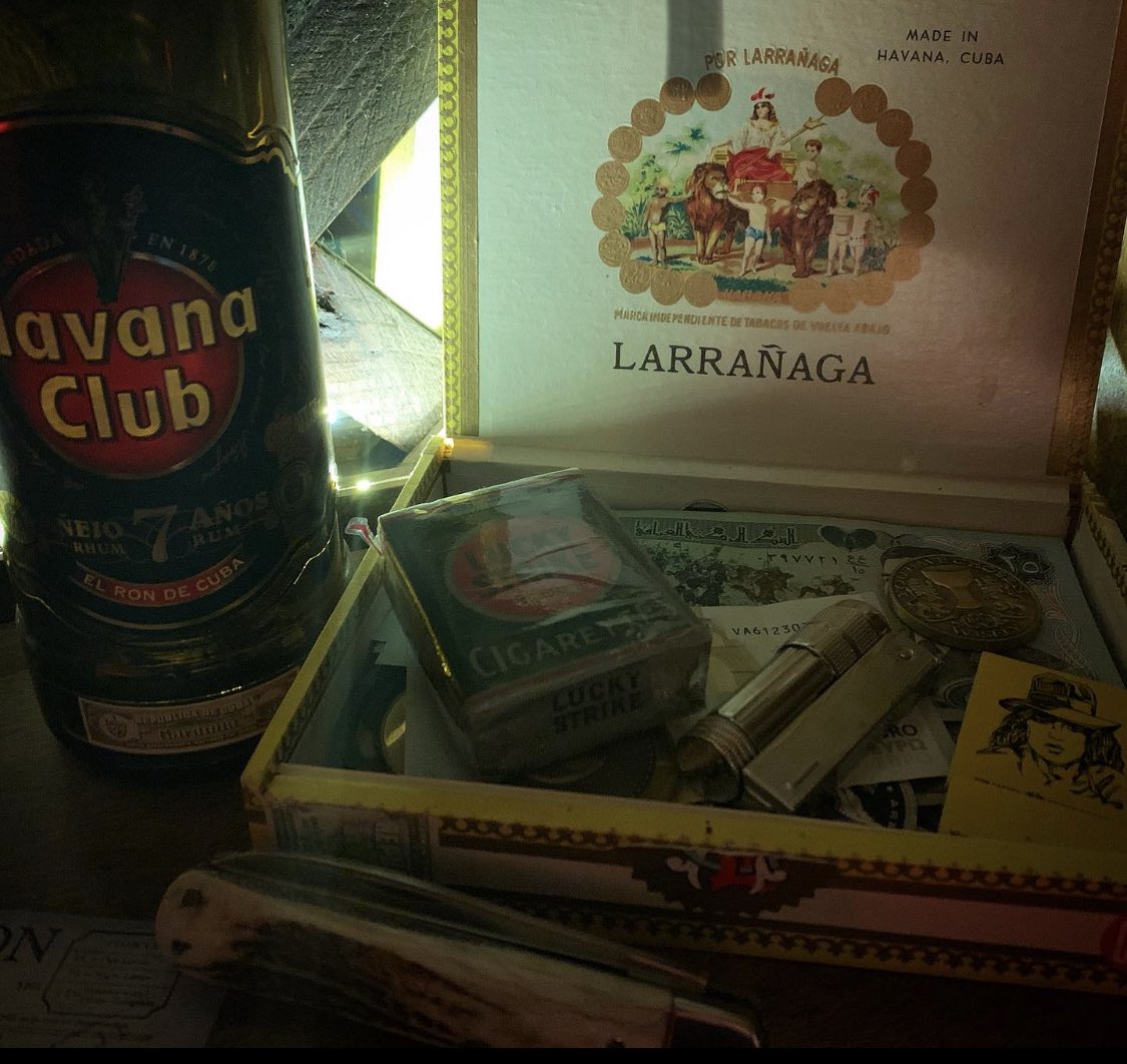 Club_ObiWan's tweet photo. A few pieces from the #RaidersoftheLostArk #RavenBar display. From Marion’s Por Larranaga Cuban cigar box, her lighter, a pack of vintage Lucky Strikes and #IndianaJones pocket knife. https://t.co/AL9VplArPN