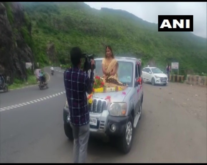 ANI's tweet photo. Maharashtra: A case has been registered against a bride for sitting on bonnet of a car & others inside without wearing a mask, during a video shoot in Dive Ghat area of Pune. The Incident was reported after a video went viral on social media(13.07)
(Screengrab from viral video) https://t.co/iVr1JQkanK
