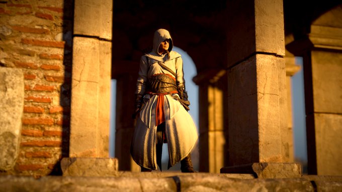 Eivor stands in the window of a tower looking out, wearing Altair's outfit.