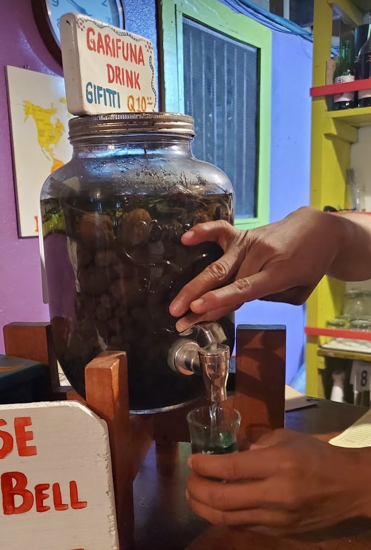 This mysterious Garifuna brew is Gifiti, rum-based bitters made by soaking roots and herbs in rum. It is used both medicinally and for enjoyment. Cheers!