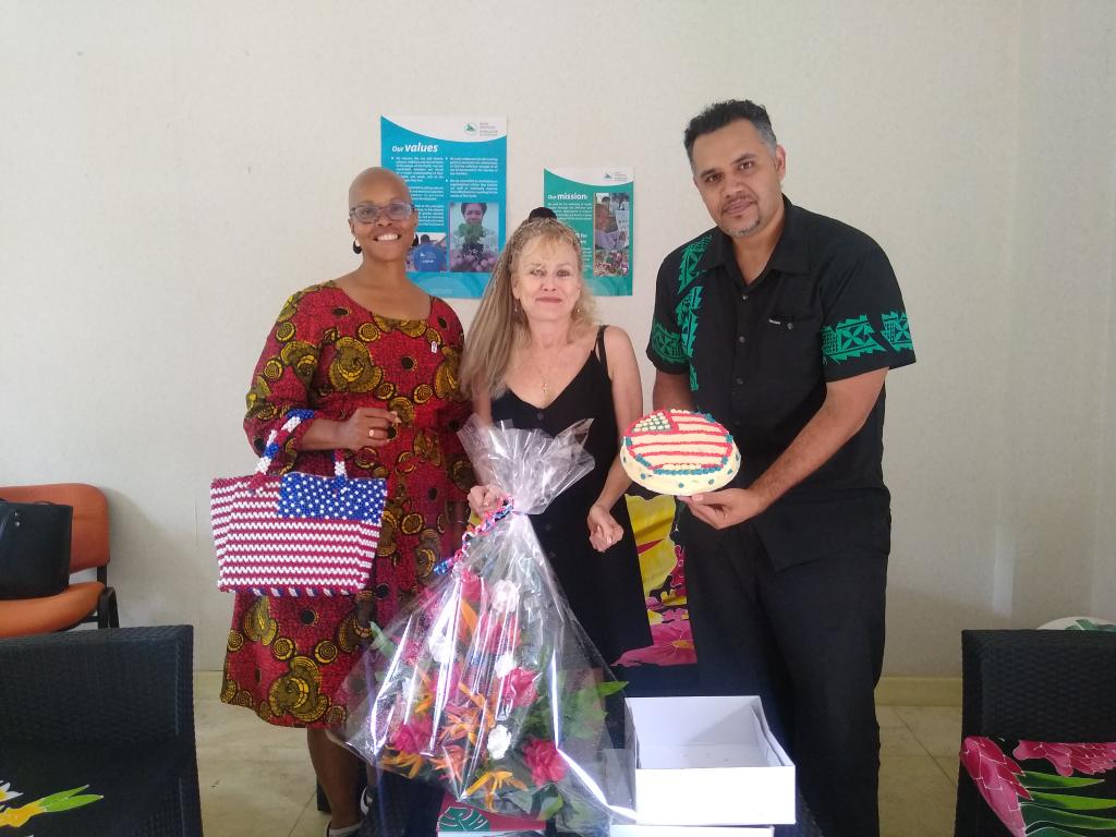 spc_live's tweet photo. A wonderful visit from new #peacecorp Director Penny and staff Brett in #Vanuatu They are calling on partners to wave the flag in anticipation of volunteers returning post Covid border closure. Thx for lovely cake and flowers, red white and blue! @USEmbassyPOM @USGovernment20 https://t.co/Tw9ecHGSuj