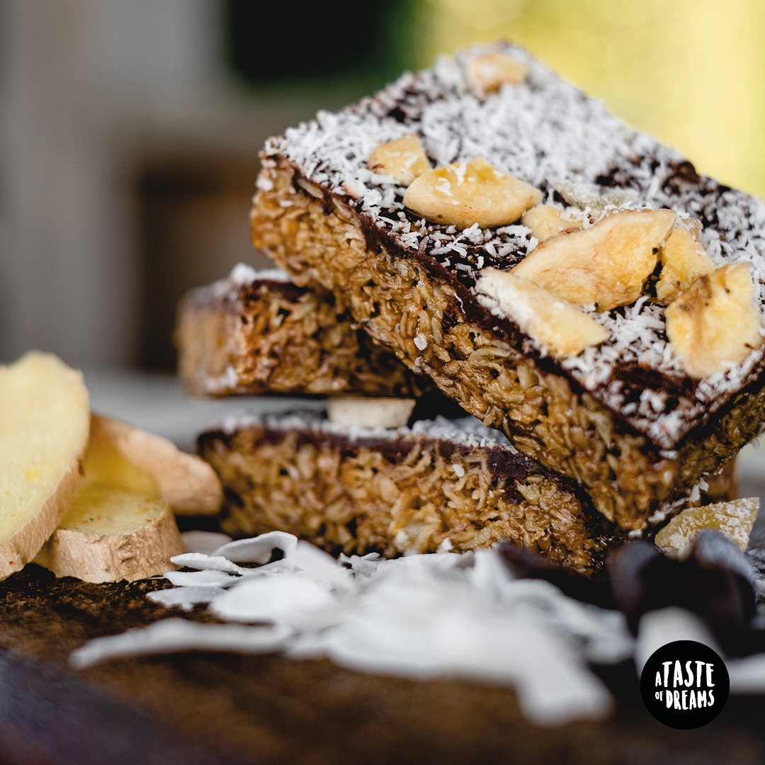 Coconut, Ginger &amp; Banana Chocolate Flapjack
The title really says it all! It's the most upmarket of flapjacks - packed with gluten free oats and topped with coconut, crystallised ginger and banana chips all set in a layer of dark Belgian chocolate.