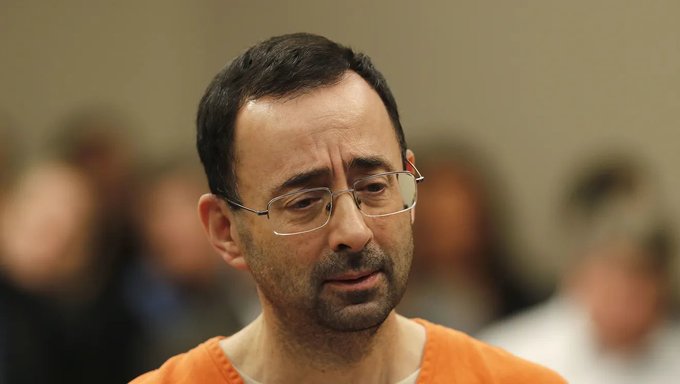 Larry Nassar, in court, looking down.