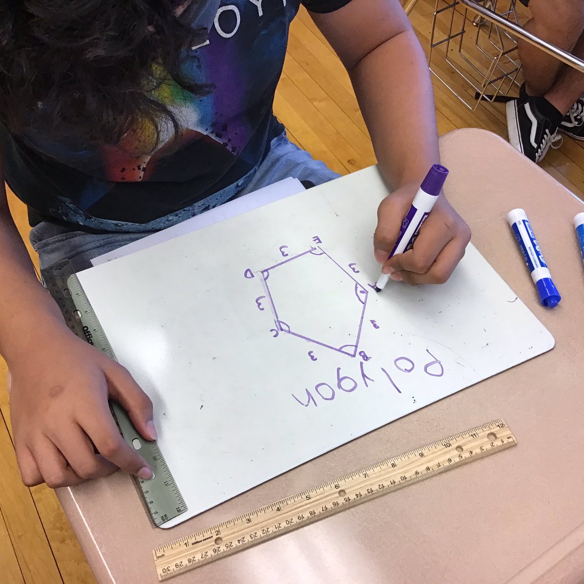 Ms. Bravo-Gonzalez is teaching a geometry class. Today’s lesson is learning how the measure the inside angles of different shapes.