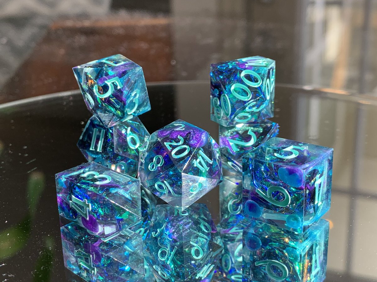 Nighthawk_Dice's tweet photo. 🦚 Peacock Paradise 🦚 Swirls of purple, green, teal, and black combine with iridescent Mylar to create dice as pretty as a peacock. #handmadedice #dnddice #dnd https://t.co/2NyRb8cWlq