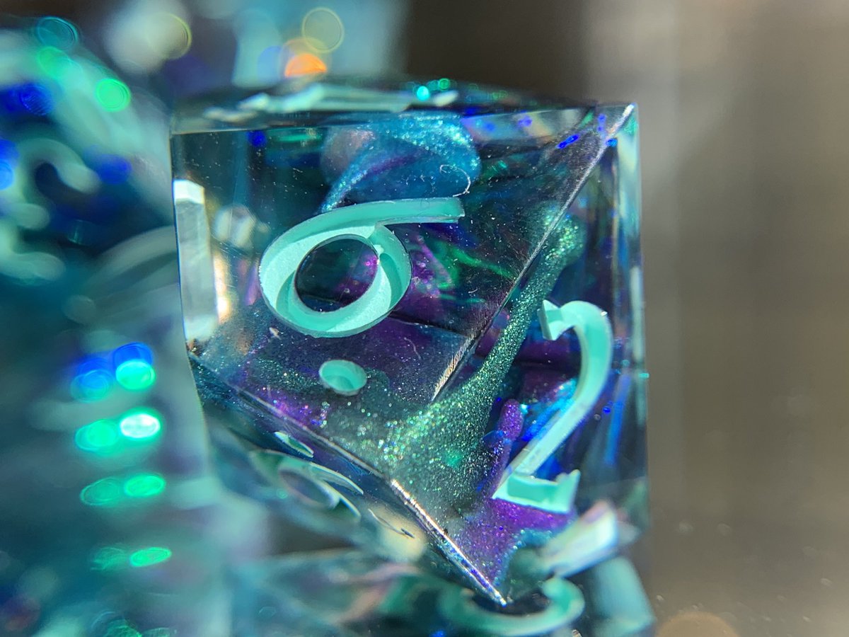Nighthawk_Dice's tweet photo. 🦚 Peacock Paradise 🦚 Swirls of purple, green, teal, and black combine with iridescent Mylar to create dice as pretty as a peacock. #handmadedice #dnddice #dnd https://t.co/2NyRb8cWlq