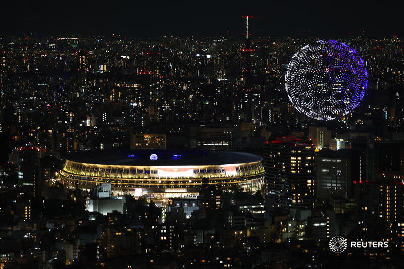 Reuters's tweet photo. Drones form a shape of the world during the #Tokyo2020 #OpeningCeremony, seen above the Olympic Stadium https://t.co/UMVAy6qKY2 https://t.co/pYbk2n3BT7