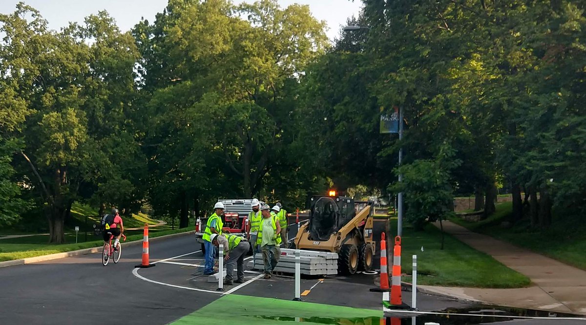 BikeWalkKC's tweet image. Happy #FeelGoodFriday! We want to give great big sweaty high fives to the public works teams doing the physical work to make our streets #PlacesforPeople. This crew is installing pre-cast curbs to add an extra layer of protection for those using #KCMO's Gillham cycle track.