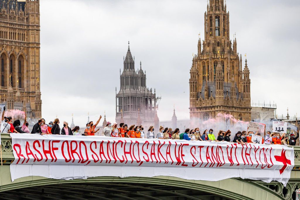 MundialMag's tweet photo. Players from Legends FC and other members of the @Super5League community expressed solidarity with the young England footballers who have received racist abuse in the wake of their Euros exit, via a banner and protest on Westminster Bridge yesterday. https://t.co/zzlItQ5wpu