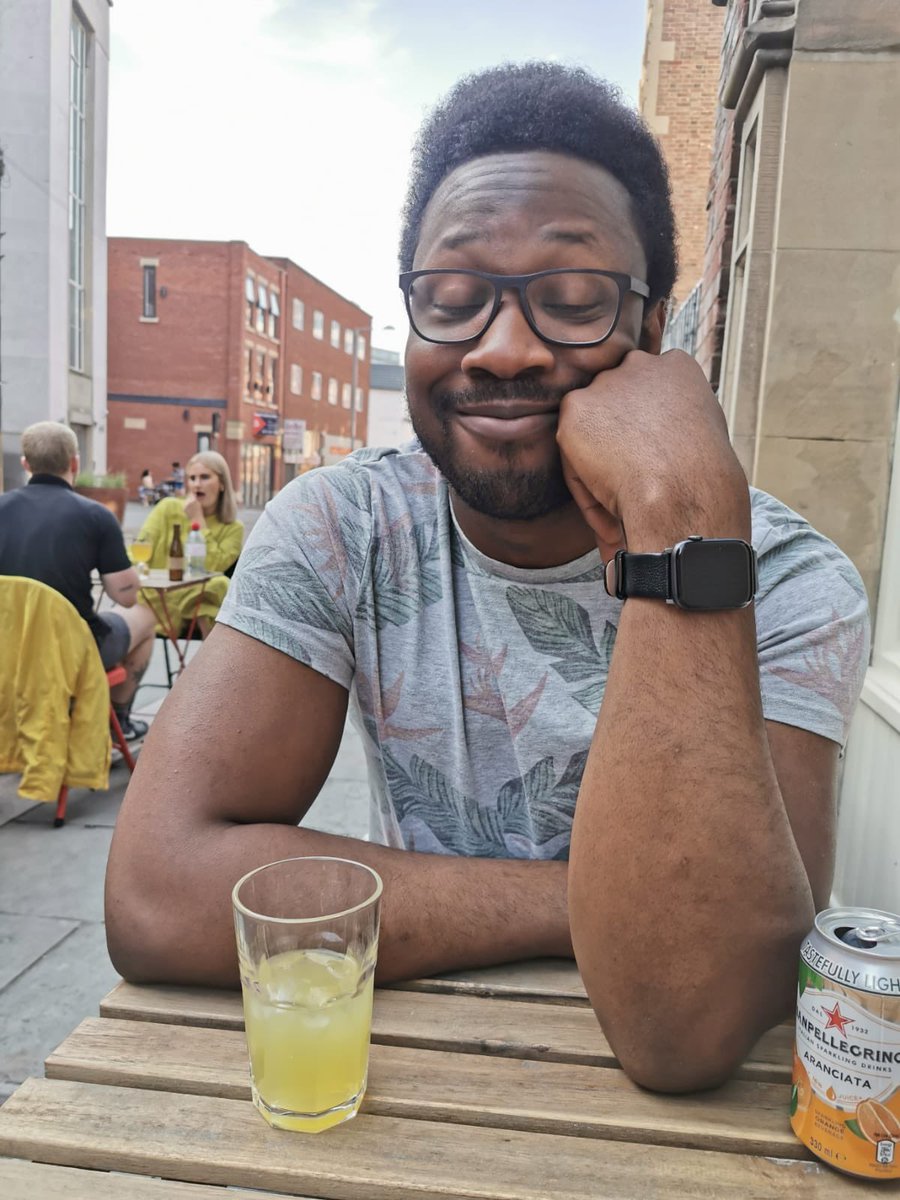 A picture of me sitting at a table, smiling