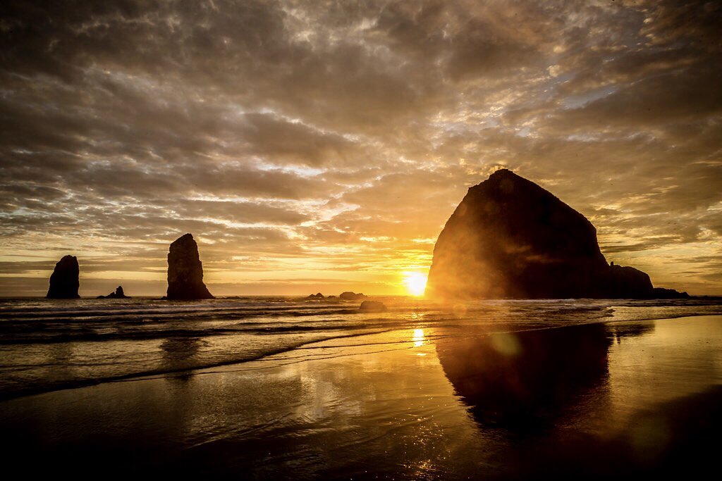 Haystack Rock at sunset on Cannon Beach in. 
