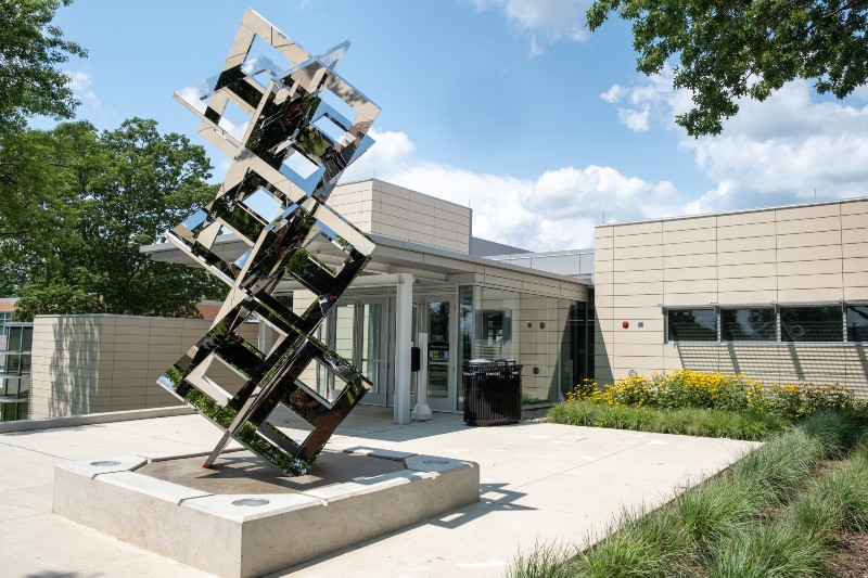 A sculpture of three cubes made with a mirrored material is the newest addition to Kent State’s Sculpture Walk on the Kent Campus.