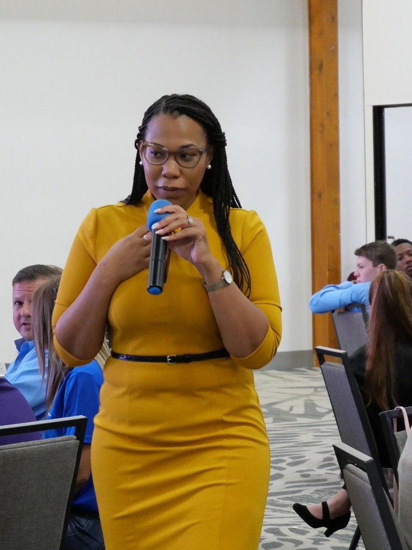 Woman speaking to a group of teens