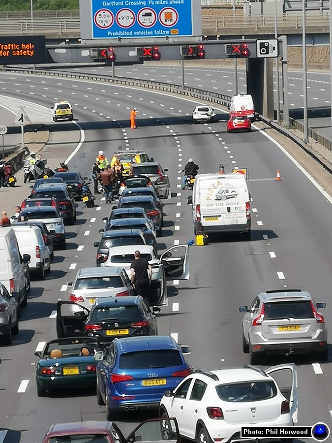 Kent_999s's tweet photo. M25 update: Drivers have been stuck on the M25 in high temperatures for nearly 5 hours after pipework reportedly fell from the underside of the Watling Street Bridge over the motorway and hit vehicles. Unknown if any injuries at the incident between J2 and J1B. https://t.co/irV4MCcrr5