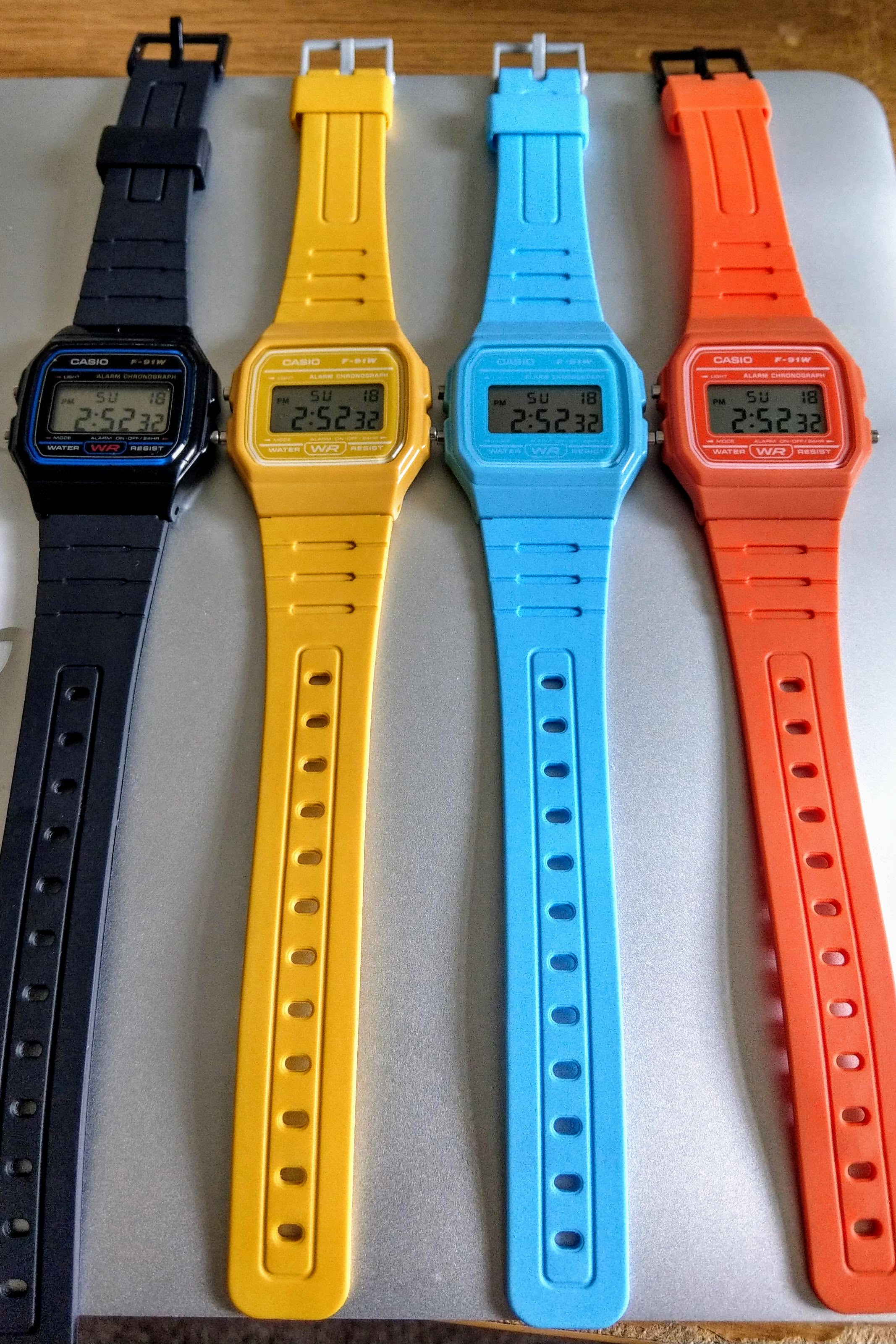 Casio F-91 Watch (Light Blue) on an Orange Nylon Strap